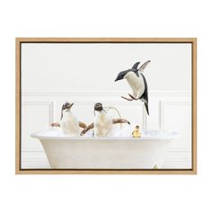 three penguins in a bathtub with bubbles and water on the bottom, while one penguin flies above