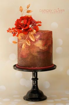 a chocolate cake with red flowers on top