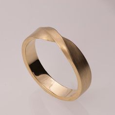 a gold wedding ring on a white background