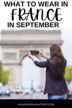 a woman taking a photo in front of the eiffel tower with her phone