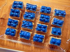 there are many blue treats in the plastic tray