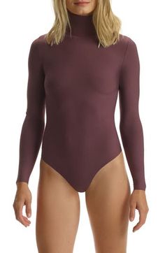 A buttery-soft bodysuit fits like a second skin thanks to ample stretch that's blended right in. Snap closure Turtleneck Long sleeves 79% modal, 21% spandex Machine wash, line dry Made in the USA of imported fabric Lingerie High Cut Solid Leotard With Lined Body, Second-skin Smoothing Bodysuit For Swimming, Smoothing Second-skin Bodysuit For Swimming, Solid High Cut Lined Bodysuit, High Cut Stretch Solid Color Leotard, Stretch High Cut Leotard, High Cut Smoothing Bodysuit, High-cut Stretch Solid Color Leotard, Chic High Stretch Swimming Bodysuit