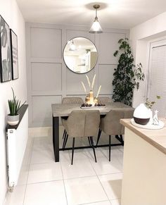 a dining room table and chairs in front of a mirror