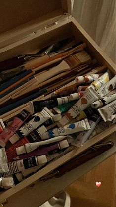 an open box filled with lots of different types of toothbrushes