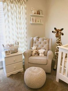 a baby's room with a chair, crib and giraffe stuffed animal