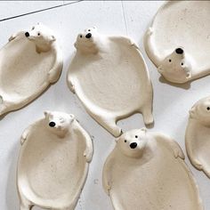 six polar bears are sitting on top of each other in the shape of egg trays