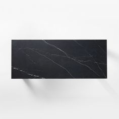 a black and white marble shelf against a wall