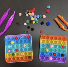 two plastic trays filled with different types of beads and scissors next to each other