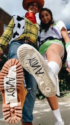 a man and woman dressed up as toy story characters posing for a photo with their shoes