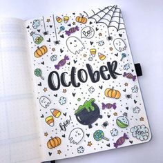 an open notebook with the word october written in black on it and lots of halloween doodles