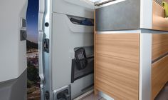 the interior of an airplane with wood paneling and stainless steel trim on the doors