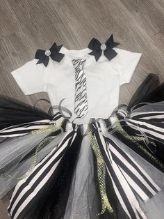 Halloween Costume Bettle Juice full tutu set. including Fluffy black and white tutu and tons of ribbon streamers and fabric, shirt and Black and White tie   Use it of Halloween or a TUTU BIRTHDAY SET - BODYSUIT OR SHIRT depending on the size orders - WoW!!   SUPER FUN. we also make in Adult sizes small starting at $109.95. message me for sizes and prices  This listing is for a hand tied, super fluffy tutu.  The color is White and black with a BlackBow and lots of ribbon streamers and black and w Beetlejuice First Birthday, Beetlejuice Tutu Costume, Baby Beetlejuice, Beetlejuice Pet Costume, Beetle Juice Women’s Costume, Halloween Costum, Tutu Size Chart, Ribbon Streamers, Black And White Halloween