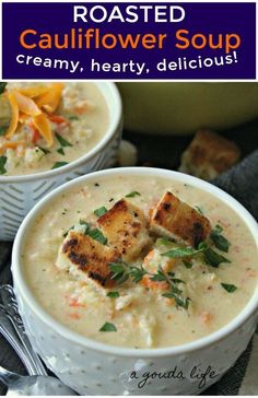 two white bowls filled with soup and topped with croutons