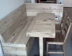 a kitchen table and bench made out of pallet wood with storage drawers on each side