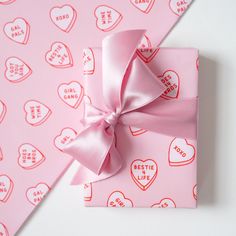 a pink wrapping paper with hearts on it