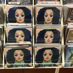 many cd cases are stacked on top of each other in the shape of a woman's face