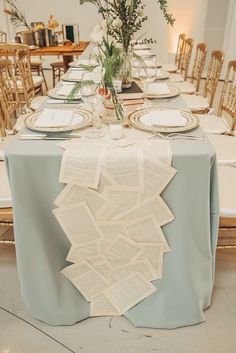 the table is set with books and place settings