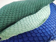 two blue and green snakeskinned fabric on top of each other in different colors