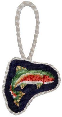 a fish ornament hanging from a rope on a white background with a blue, red and green design