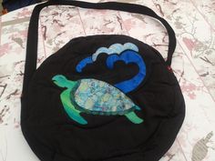 a black purse with a turtle on it