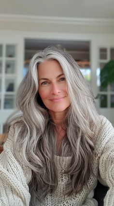 More and more women are embracing their natural gray hair and experimenting with stunning long hairstyles that showcase their silver strands. Whether you're transitioning to gray hair, have fully embraced your silver strands, or simply Women With Natural Grey Hair, Grey Extensions Hair, How To Embrace Grey Hair, Long Salt And Pepper Hair Over 50, Gray Long Hair Older Women, Beautiful Grey Hair, Long Layered Grey Hair, Long Silver Hair Older Women, Gray Streak In Front Of Hair