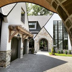 an arched doorway leading to a large house