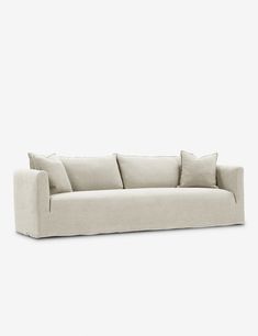 a white couch with four pillows on it