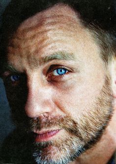 a close up of a man with blue eyes