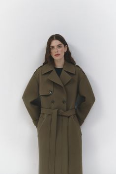 Our khaki trench coat showcases a slightly exaggerated silhouette, adding a unique and fashionable twist to a classic design. It features a notched collar and a double-breasted front fastening for a timeless look. The belted waist adds a touch of sophistication and allows for a customizable fit. With side slip pockets, you can keep your essentials within reach. Epaulettes on the shoulders add a stylish and military-inspired detail. Crafted with care and attention to detail, this Khaki trench coa Wedding Skirt Top, Silk Bridal Gown, Trench Coat Fall, Vision Book, Khaki Trench, Khaki Trench Coat, Cape Wedding Dress, Bridal Tops, Bridal Gowns Mermaid