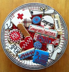 a bowl filled with decorated cookies on top of a wooden table