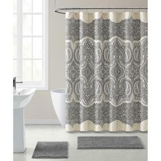 a bathroom with a shower curtain and rug