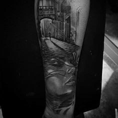 a man's arm with a black and white photo on it