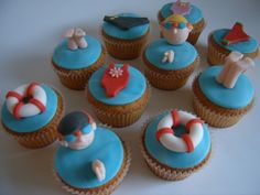 cupcakes with blue frosting and decorations on them