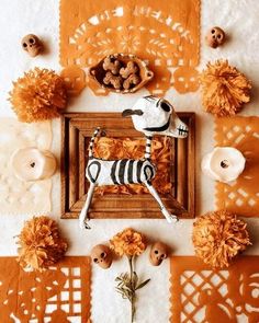 a table topped with orange flowers and decorations