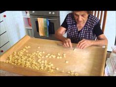 an older woman is cutting up some food