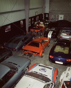 a garage filled with lots of different types of cars parked in front of each other