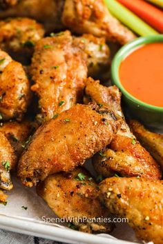 chicken wings with dipping sauce on the side