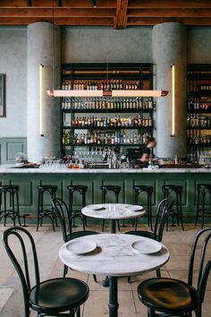 an instagram photo of a restaurant with tables and chairs in front of the bar