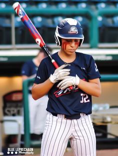 a baseball player holding a bat on top of a field