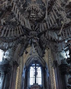 the interior of an old church with many bones hanging from it's ceiling