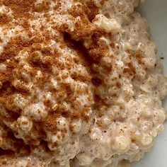 a bowl filled with oatmeal sitting on top of a table