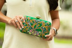 Immerse yourself in a verdant oasis with our enchanting green Gond Art clutch bags. Each piece is a canvas of nature's splendor, meticulously hand-painted with intricate designs inspired by the graceful peacock, lively sparrows, and a harmonious symphony of birds amidst lush trees. Unleash your inner art connoisseur with these dreamlike accessories, perfect for elevating your evening ensemble. Gond Art, a timeless tradition from Madhya Pradesh, India, breathes life into our clutches through its Artistic Green Rectangular Shoulder Bag, Hand Painted Green Bags For Everyday, Green Hand-painted Bag As Gift, Artistic Green Shoulder Bag As Gift, Green Hand Painted Bags For Gift, Everyday Use Hand Painted Green Bags, Hand Painted Green Bags For Gift, Hand Painted Green Rectangular Shoulder Bag, Green Hand Painted Rectangular Shoulder Bag