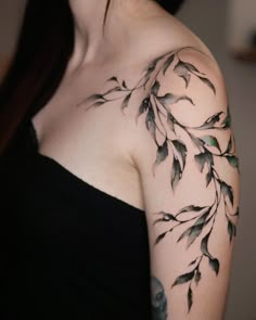 a woman's shoulder with leaves on it