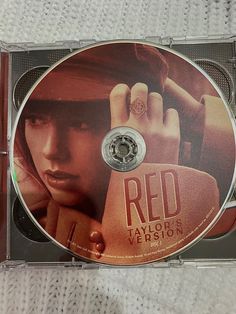 the dvd cover for red is shown on a white cloth covered surface with an image of a woman holding her hand up to her face