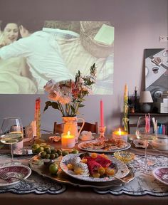 a table with plates and candles on it