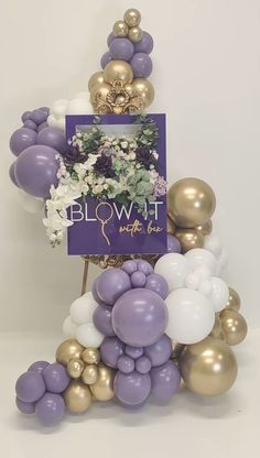 balloons and flowers are arranged in the shape of a tower with a sign that reads blow - it party time