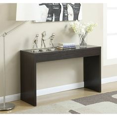 a modern console table with flowers on top