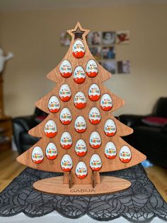 a wooden christmas tree with eggs in it