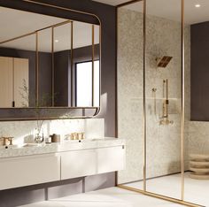 a bathroom with marble counter tops and gold accents