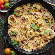 a skillet filled with ravioli and cheese